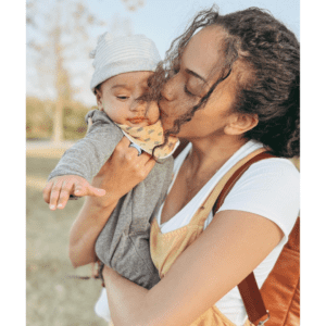 6 month old being kissed my mom